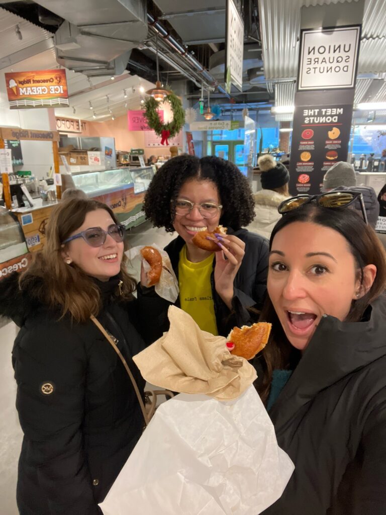 A selfie of three women holding donuts at Union Square Donuts.